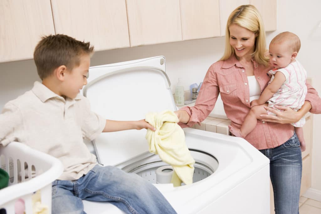 Mother And Children Doing Laundry Mother And Children Doing Laundry